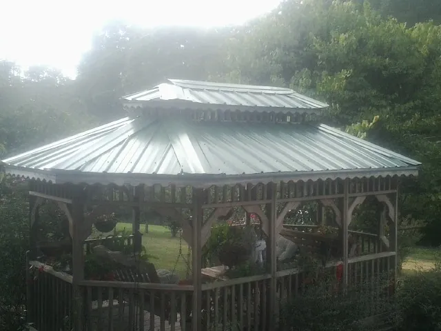Two tier green metal roof on a garden gazebo in Caledonia